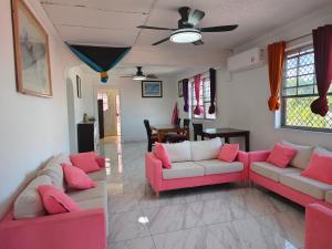 a living room with pink and white couches at Da Pink And White Palace in Nassau