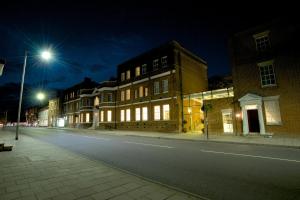 a city street at night with lights on at GreyFriars in Colchester