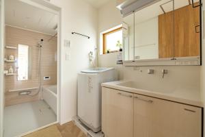 a white bathroom with a sink and a washing machine at 鎌倉-Reihome in Kamakura +32 photos