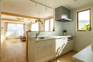 a kitchen with a sink and a stove at 鎌倉-Reihome in Kamakura