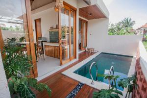 a house with a swimming pool in a yard at Thousand Sunday Ubud in Ubud