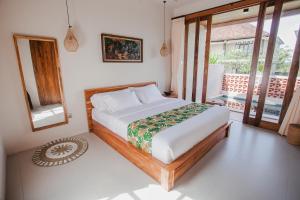 a bedroom with a bed and a large window at Thousand Sunday Ubud in Ubud +37 photos