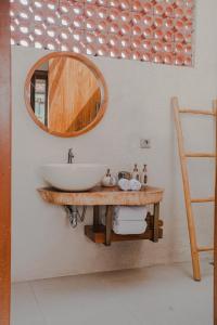 a bathroom with a sink and a mirror at Thousand Sunday Ubud in Ubud