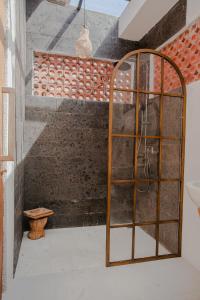 a room with a shower with a glass door at Thousand Sunday Ubud in Ubud