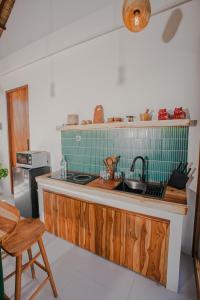 a kitchen with a sink and a counter top at Thousand Sunday Ubud in Ubud