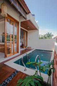 a swimming pool in the backyard of a house at Thousand Sunday Ubud in Ubud