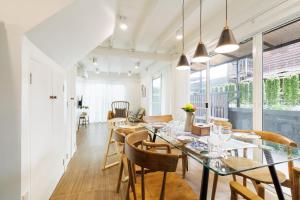 a dining room with a glass table and chairs at Baan Boon in Bangkok