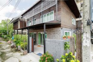 a house is shown with plants in front of it at Baan Boon in Bangkok