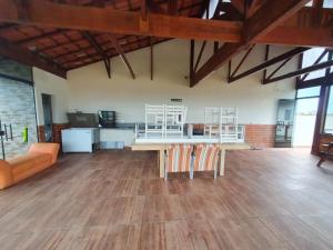 a large room with a table and chairs in it at Linda Casa Com Vista Pro Mar in Ilha Comprida