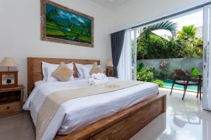 Postel nebo postele na pokoji v ubytování Sujiwa Ubud Hotel & Villa + 37 fotografií