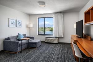 a living room with a couch and a tv at TownePlace Suites by Marriott Salt Lake City-West Valley in West Valley City
