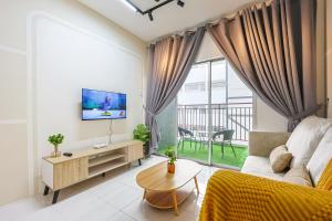 a living room with a couch and a tv at Premium Family Homestay in Cameron Highlands Clover Home 1-06 in Brinchang