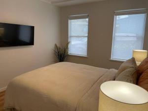 a bedroom with a bed and a flat screen tv at 'Rocks Retreat' - Dunbar Court Unit 2 - Renovated & Centrally Located in South West Rocks