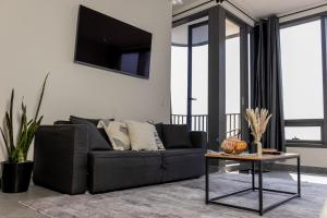 a living room with a black couch and a table at KingSize Suite in Reforma Jacuzzi & Awesome Mexico City View in Mexico City