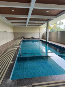 a large swimming pool with a blue pool at Aami dhivahi guest house 01 in Trivandrum