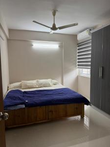 a bedroom with a bed with a ceiling fan at Aami dhivahi guest house 01 in Trivandrum +10 photos