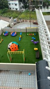 an aerial view of a playground with toys on the grass at Aami dhivahi guest house 01 in Trivandrum