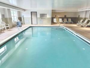 a large swimming pool with blue water in a building at Country Inn & Suites by Radisson, Harrisonburg, VA in Harrisonburg