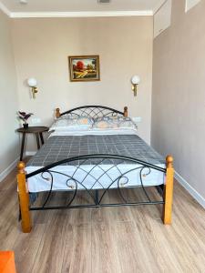 a bedroom with a bed with a metal frame at Квартира-студия в центре города in Balqash