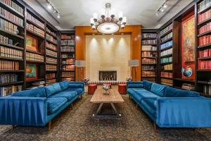 a large library with blue couches and a fireplace at Bethesda 1BR w Concierge Gym WD nr Metro WDC-333 in Bethesda