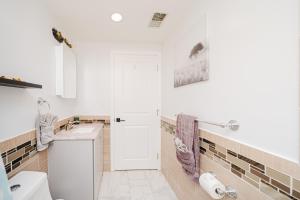 a bathroom with a toilet and a sink at 74L - 2BR Quincy - Cozy Couple Hideout near Wollaston Beach in Quincy +52 photos
