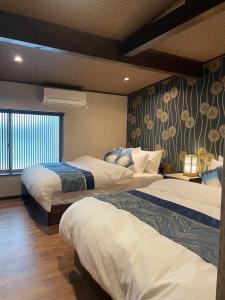 Ένα ή περισσότερα κρεβάτια σε δωμάτιο στο 京町家ゲストハウス遥月