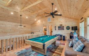 a living room with a pool table in a cabin at The Foxtail Lodge in Gatlinburg