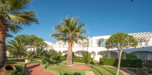 a resort with palm trees and a golf course at Ona Village Cala d'Or in Cala d´Or