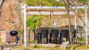 a group of chairs sitting under ailion with a grill at アレーズドヴィラsetouchi in Setouchi