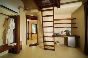 a room with a spiral staircase in a house at Nangyuan Island Dive Resort in Ko Tao