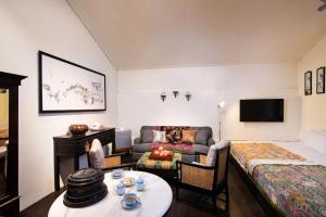 a room with a bed and a couch and a table at Muntri Mews in George Town