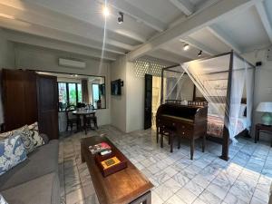 a living room with a bed and a piano at Muntri Mews in George Town +36 photos