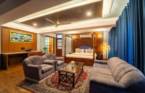 a living room with a bed and a couch and a table at The Kurki Heritage in Jaipur