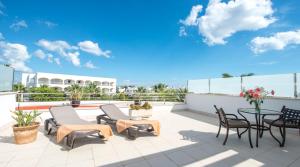 a patio with chairs and a table on a roof at Ona Village Cala d'Or in Cala d´Or