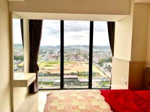 a bedroom with a large window with a view at ONE BEDROOM APARTMENT POLLUX MEISTERSTADT BATAM centre in Bagam