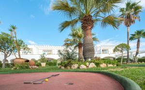 a resort with palm trees and a putting green at Ona Village Cala d'Or in Cala d´Or