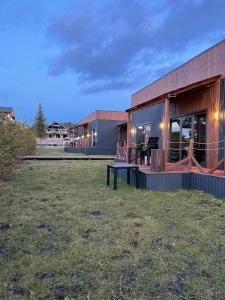 a building with a bench in the grass in front of it at Atyrau Avenue in Vorobʼyëvka