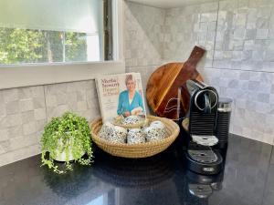 a kitchen counter with a basket with a picture of a woman at Heritage 5BR Queenslander- Walk to CBD&South Bank, 3 Parking in Brisbane +38 photos