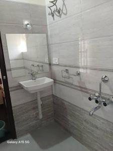 a bathroom with a sink and a mirror at Palm Vista Vacations Barkur Udupi District in Bārkūr