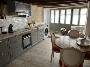 a kitchen with a table and a dining room at Maison Centre de Loches in Loches