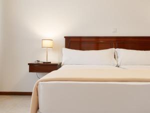 Cama ou camas em um quarto em Hotel Central Santa Maria