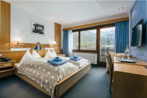 Postel nebo postele na pokoji v ubytování Hotel Etoile & Alpenperle Residences