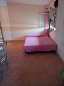 a bedroom with a pink bed in a room at Frajà Resort in Palmi +15 photos