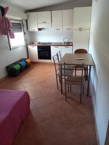 a kitchen and dining room with a table and chairs at Frajà Resort in Palmi