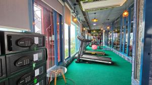 a gym with a person exercising on a treadmill at BlueTel Re'sidencE Bangkok IMPACT - 1 Time Drop-Off Service to Impact in Nonthaburi