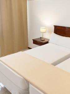 Cama ou camas em um quarto em Hotel Central Santa Maria