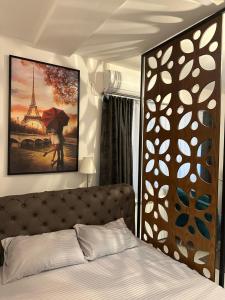a bedroom with a bed and a picture of the eiffel tower at Blue Sky in Skopje