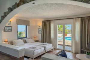 A bed or beds in a room at Pano Stalos Villas