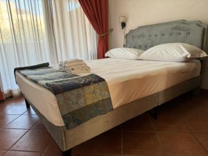 a bedroom with a large bed with white sheets and pillows at EURO HOUSE INN airport in Fiumicino