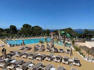 a large pool with lounge chairs and umbrellas at Sea View Amazing in Saint-Raphaël